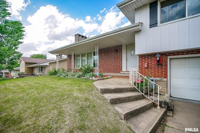 property entrance featuring brick siding, board and batten siding, a chimney, and a yard
