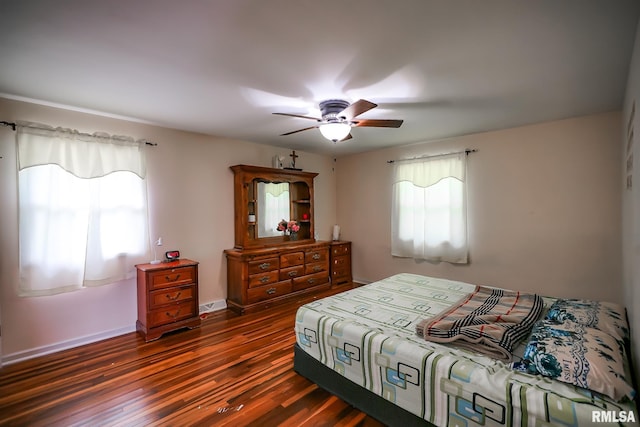 bedroom featuring dark wood-type flooring, ceiling fan, and baseboards