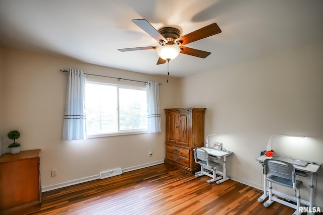 home office with a ceiling fan, wood finished floors, and baseboards