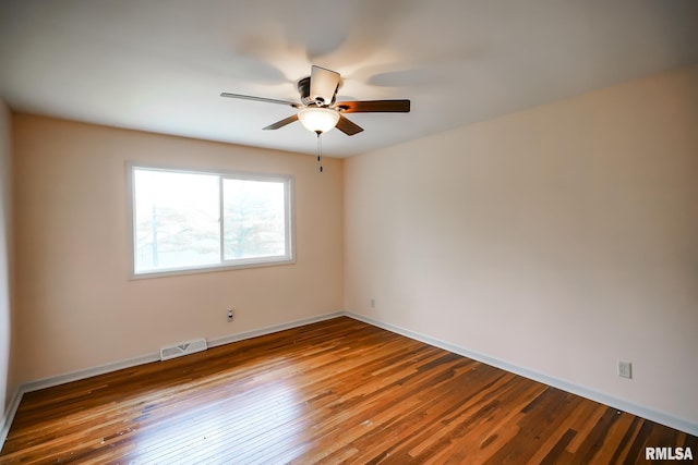 empty room featuring ceiling fan, wood-type flooring, and baseboards