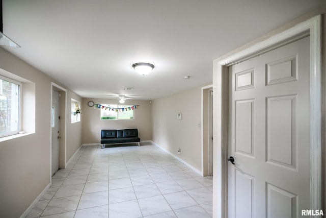 hall featuring baseboards