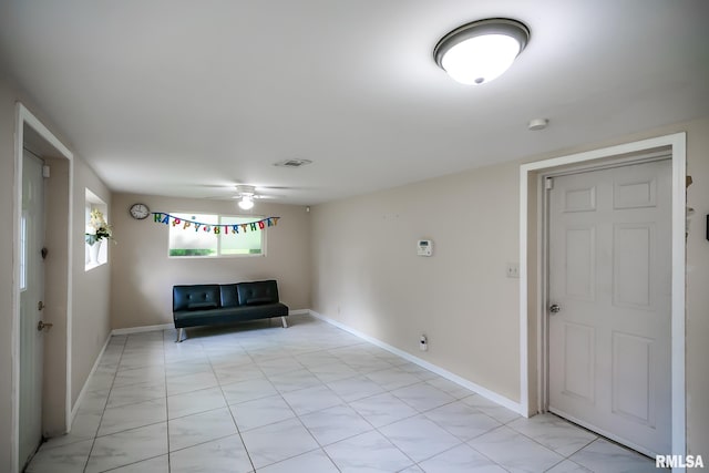 entryway with a ceiling fan and baseboards