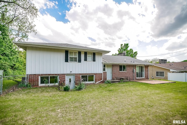 back of house featuring a patio area, a chimney, and brick siding