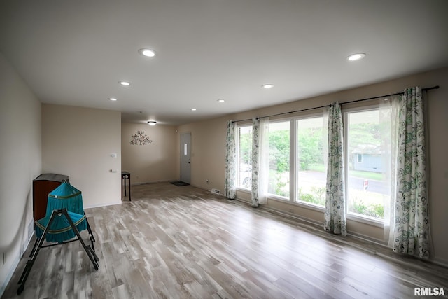 empty room featuring recessed lighting, light wood-style floors, and baseboards