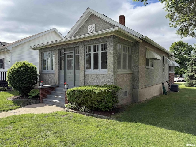 844 Walnut Rd, La Salle, IL 61354 - bungalow-style home featuring a chimney, a front lawn, and central AC