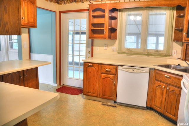 298 Jana Rd, Macomb, IL 61455 - kitchen with white dishwasher, a sink, light countertops, and brown cabinets