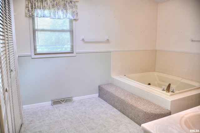 298 Jana Rd, Macomb, IL 61455 - bathroom featuring a garden tub, baseboards, and tile patterned floors