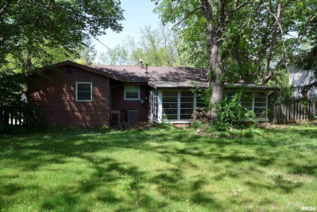 298 Jana Rd, Macomb, IL 61455 - back of house with a sunroom, cooling unit, and roof with shingles