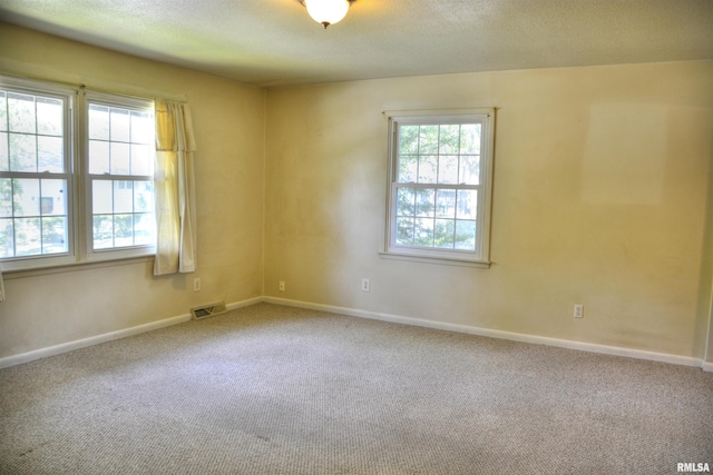298 Jana Rd, Macomb, IL 61455 - carpeted spare room featuring baseboards and a textured ceiling