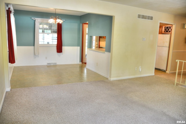 298 Jana Rd, Macomb, IL 61455 - empty room featuring a chandelier, wainscoting, and baseboards