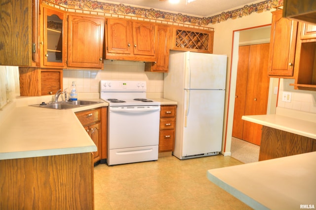 298 Jana Rd, Macomb, IL 61455 - kitchen featuring white appliances, decorative backsplash, brown cabinets, and light countertops