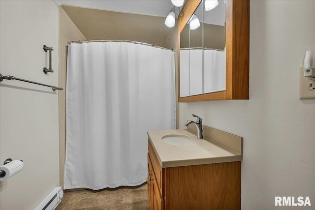 bathroom featuring baseboard heating, vanity, and curtained shower