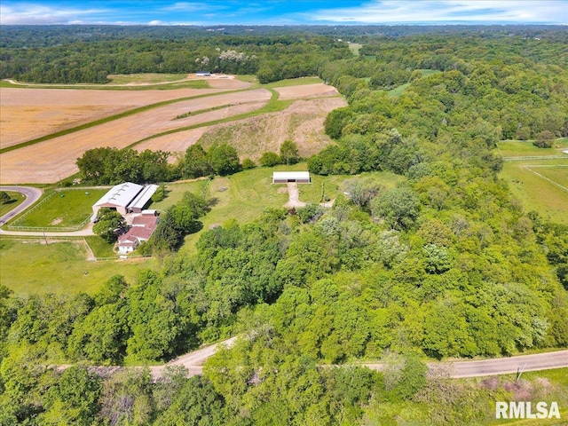 view of property location with a heavily wooded area