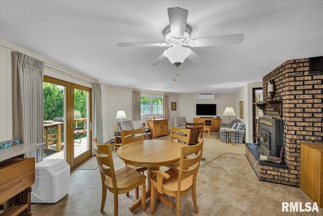 dining room with a ceiling fan and a wood stove