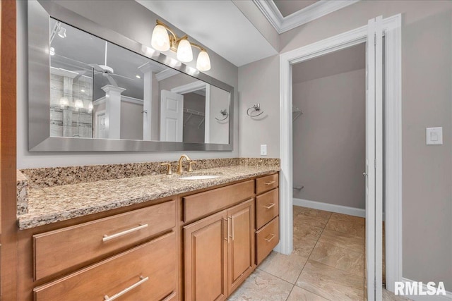 11116 N Oakwood Dr, Peoria, IL 61615 - full bath featuring crown molding, vanity, a spacious closet, baseboards, and a shower