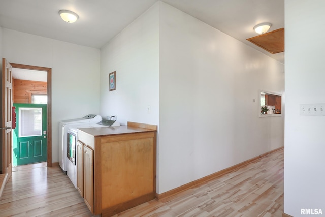 113 W Essex St, Glasford, IL 61533 - laundry area with light wood finished floors, cabinet space, washer and clothes dryer, and baseboards