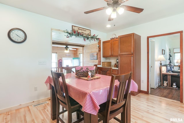 113 W Essex St, Glasford, IL 61533 - dining room featuring ceiling fan, light wood-style floors, baseboards, and plenty of natural light