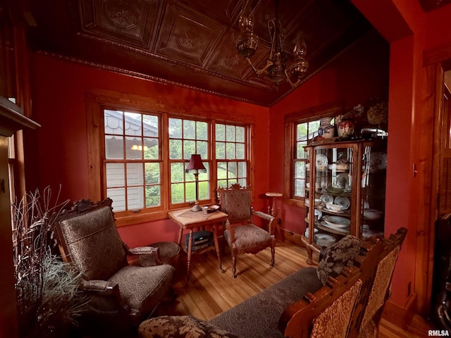 429 S Madison St, Macomb, IL 61455 - sitting room with wood finished floors, healthy amount of natural light, a chandelier, and an ornate ceiling