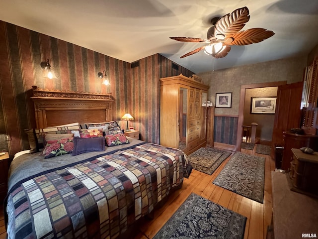 429 S Madison St, Macomb, IL 61455 - bedroom with hardwood / wood-style flooring, wallpapered walls, and a ceiling fan
