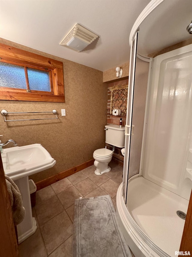 429 S Madison St, Macomb, IL 61455 - full bathroom featuring a stall shower, tile patterned flooring, toilet, and baseboards