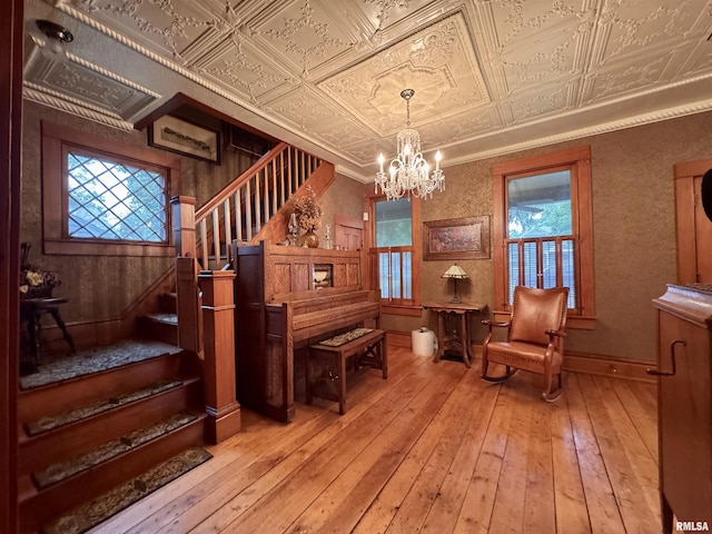 429 S Madison St, Macomb, IL 61455 - sitting room featuring an ornate ceiling, stairway, a chandelier, and light wood-style floors