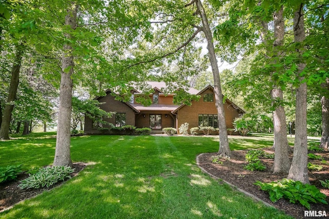 view of front facade featuring a front yard and brick siding