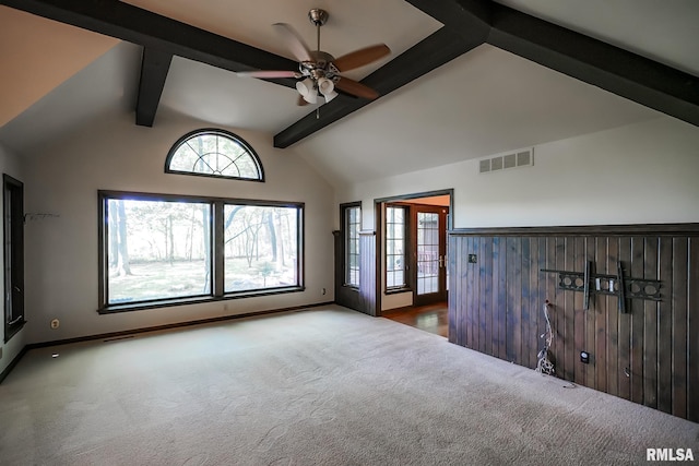 spare room featuring carpet, ceiling fan, and baseboards