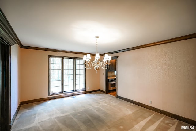 unfurnished room featuring light colored carpet, a chandelier, ornamental molding, and baseboards