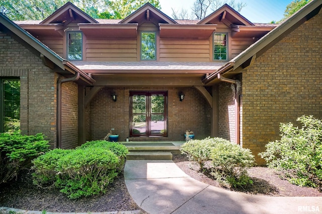entrance to property with covered porch and brick siding