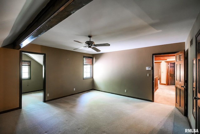 empty room featuring light carpet, a ceiling fan, and baseboards