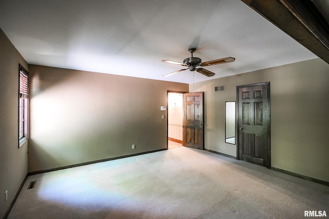 unfurnished bedroom featuring baseboards, light carpet, and ceiling fan