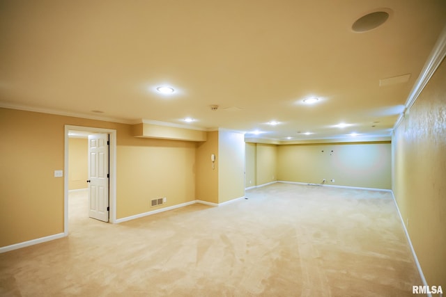 finished below grade area with crown molding, recessed lighting, light carpet, and baseboards