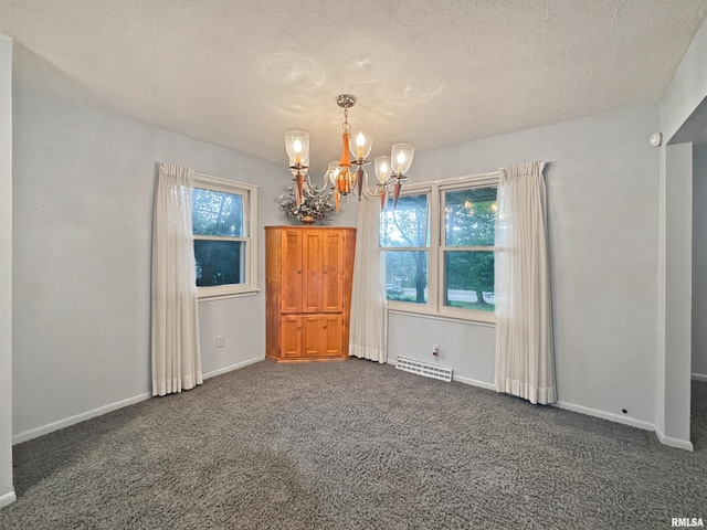 6006 N Big Hollow Rd, Peoria, IL 61615 - carpeted spare room featuring a chandelier, a textured ceiling, and baseboards