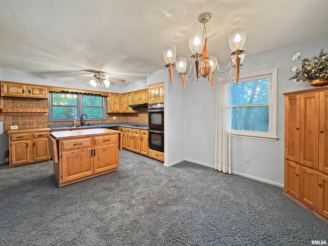 6006 N Big Hollow Rd, Peoria, IL 61615 - kitchen with a sink, a ceiling fan, a chandelier, dark colored carpet, and backsplash