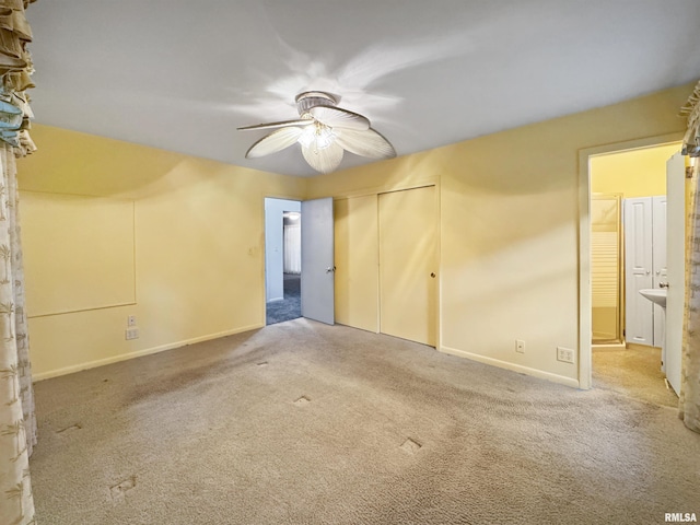 6006 N Big Hollow Rd, Peoria, IL 61615 - unfurnished bedroom featuring carpet flooring, a closet, connected bathroom, baseboards, and ceiling fan