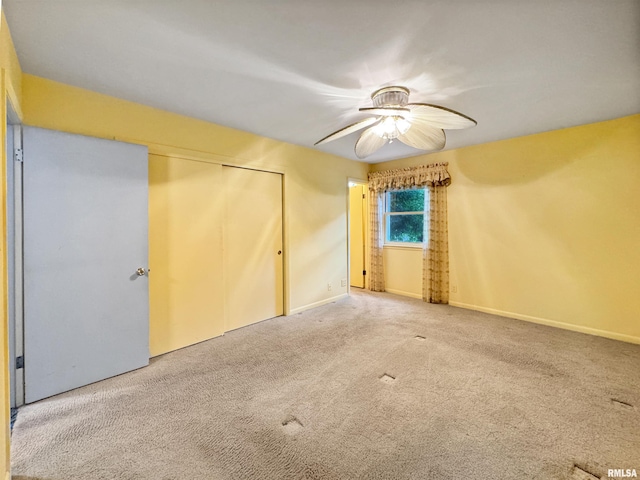 6006 N Big Hollow Rd, Peoria, IL 61615 - unfurnished bedroom featuring carpet flooring, a closet, baseboards, and ceiling fan