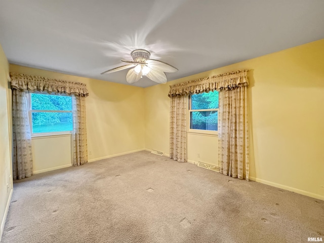 6006 N Big Hollow Rd, Peoria, IL 61615 - empty room featuring healthy amount of natural light, a ceiling fan, carpet floors, and baseboards