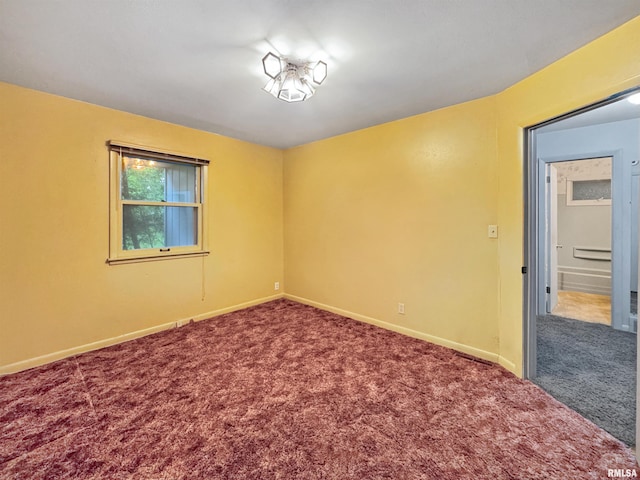 6006 N Big Hollow Rd, Peoria, IL 61615 - carpeted spare room with baseboards and a baseboard radiator