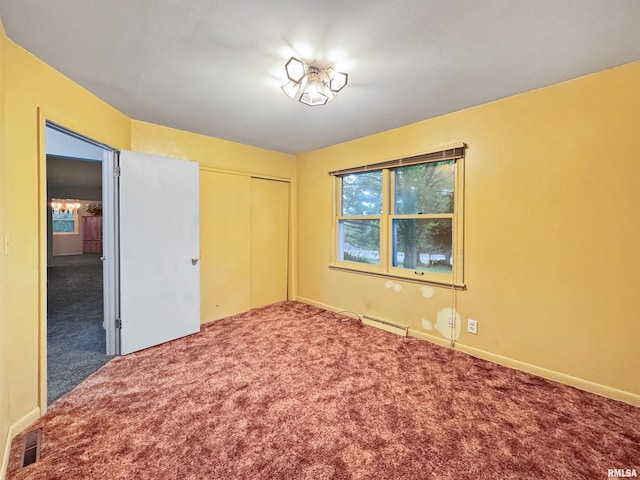 6006 N Big Hollow Rd, Peoria, IL 61615 - unfurnished bedroom with a baseboard heating unit, carpet flooring, and a closet