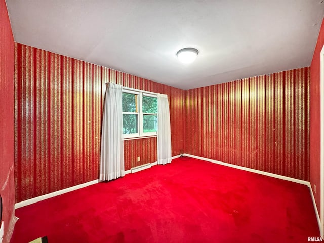 6006 N Big Hollow Rd, Peoria, IL 61615 - empty room featuring carpet floors, wallpapered walls, and baseboards