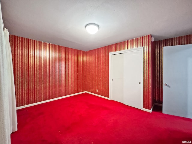 6006 N Big Hollow Rd, Peoria, IL 61615 - unfurnished bedroom with carpet flooring, a closet, and wallpapered walls