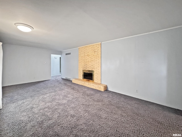 6006 N Big Hollow Rd, Peoria, IL 61615 - unfurnished living room with a brick fireplace, carpet flooring, and baseboards
