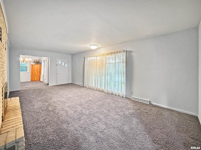 6006 N Big Hollow Rd, Peoria, IL 61615 - unfurnished living room with carpet flooring, baseboards, and a chandelier