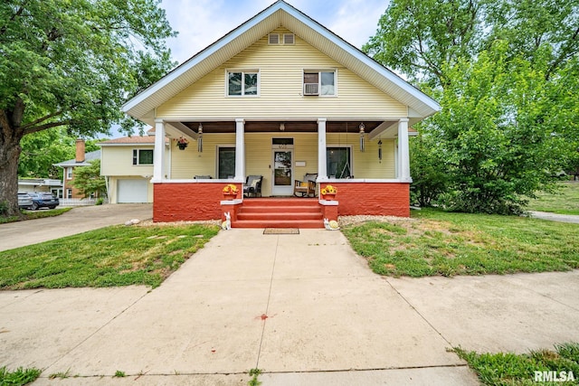 405 Washington St, Pekin, IL 61554 - view of front of home with a porch, an attached garage, a front lawn, and driveway
