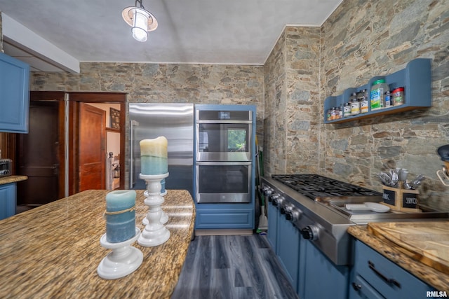 405 Washington St, Pekin, IL 61554 - kitchen with stainless steel appliances, blue cabinets, and dark wood finished floors