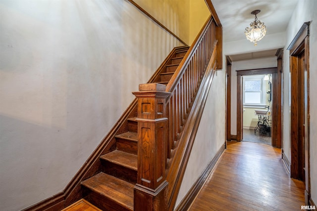 405 Washington St, Pekin, IL 61554 - stairway featuring wood finished floors, baseboards, and a chandelier
