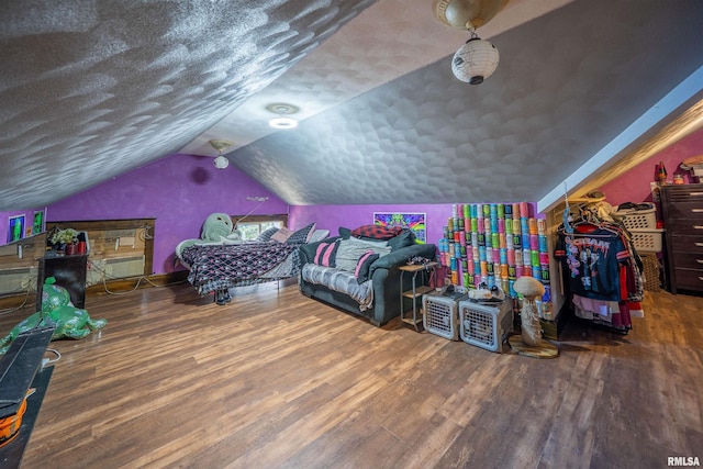 405 Washington St, Pekin, IL 61554 - bedroom with wood finished floors, lofted ceiling, and a textured ceiling