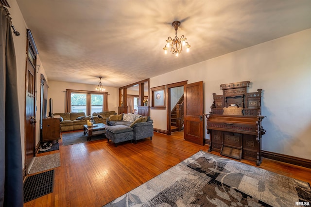 405 Washington St, Pekin, IL 61554 - living area featuring a chandelier, wood-type flooring, stairway, and baseboards