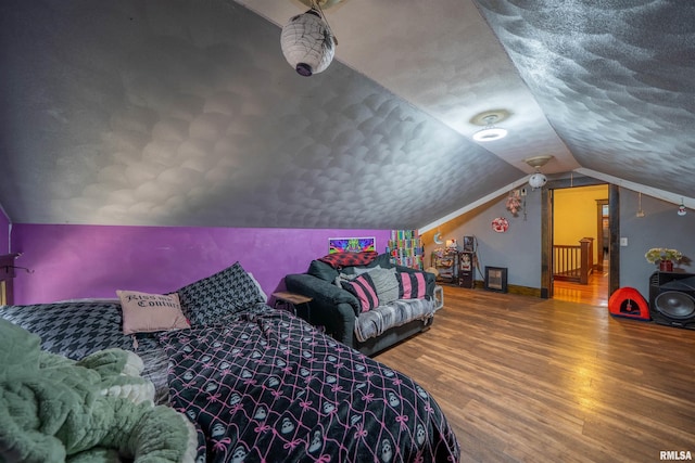 405 Washington St, Pekin, IL 61554 - bedroom with lofted ceiling, wood finished floors, and a textured ceiling