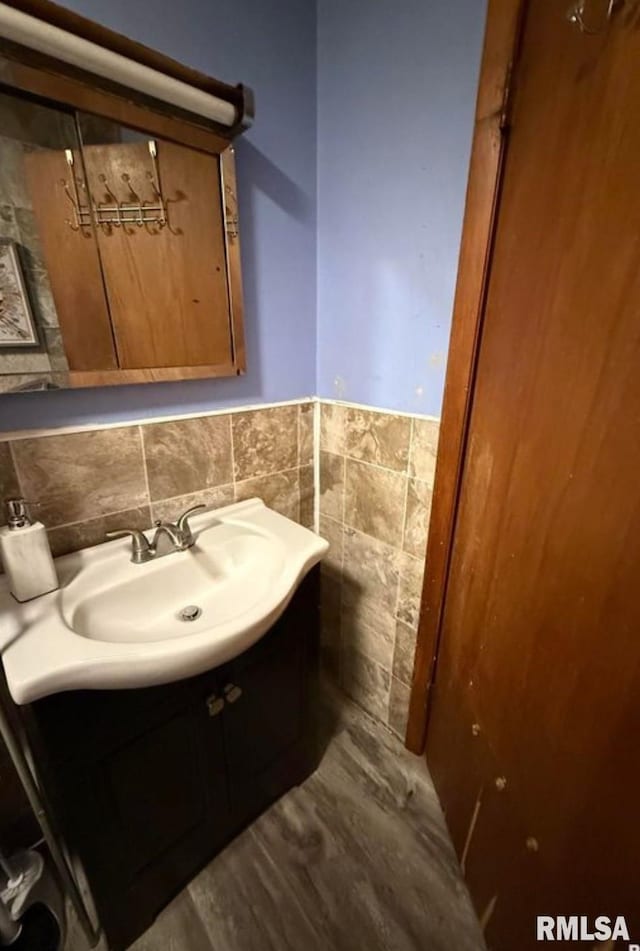 405 Washington St, Pekin, IL 61554 - bathroom with vanity, tile walls, and a wainscoted wall